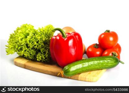 Vegetables on hardboard in kitchen for salad, isolated on white