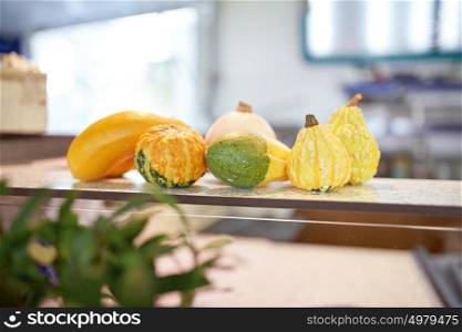 vegetables, sale and food concept - pumpkins on stall. pumpkins on stall
