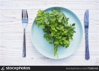 vegetarian and vegan menu - a bunch of parsley on a plate. healthy diet