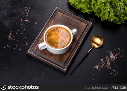 Vegetarian and vegan yellow split pea soup or stew with potato, carrot and celery in a bowl. Chicken noodle soup with parsley and vegetables in a white plate