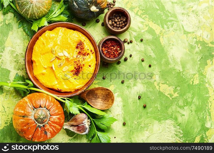 Vegetarian autumn pumpkin cream soup.Flat lay with copy space. Pumpkin vegan soup