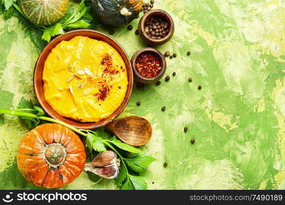 Vegetarian autumn pumpkin cream soup.Flat lay with copy space. Pumpkin vegan soup