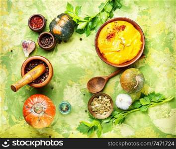 Vegetarian autumn pumpkin cream soup.Pumpkin soup and organic pumpkins. Pumpkin soup on the table