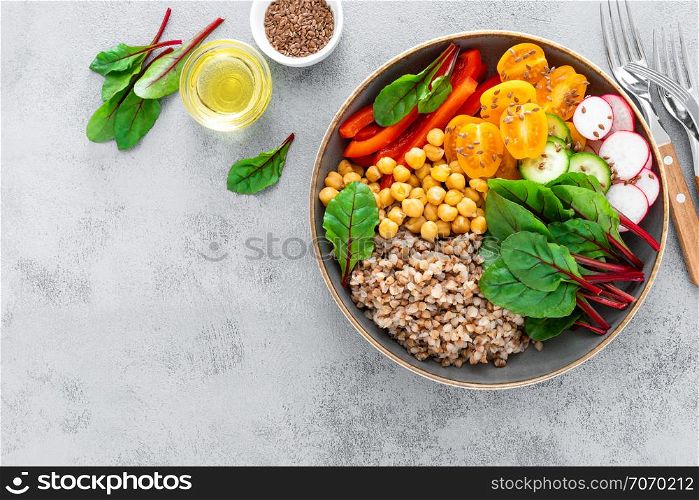 Vegetarian Buddha bowl with boiled buckwheat, chickpea and vegetables, top view