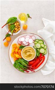 Vegetarian Buddha bowl with hummus and vegetables, top view