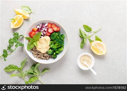Vegetarian Buddha bowl with quinoa, vegetables and hummus, healthy food concept