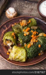 Vegetarian cabbage rolls on plate. Ukrainian vegetable dietary cabbage rolls in leaf of savoy cabbage