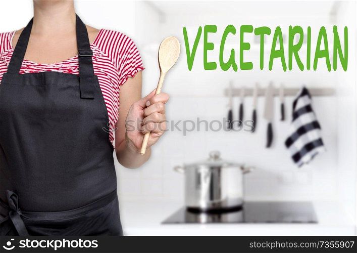 vegetarian chef holding wooden spoon background.. vegetarian chef holding wooden spoon background