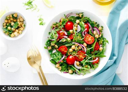 Vegetarian chickpea salad with tomatoes, arugula, parsley, spinach and red onion. Healthy food, diet. Top view