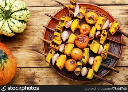 Vegetarian delicious pumpkin and tomato shashlik. Pumpkin fried on skewers.. Grilled vegetable shish kebab