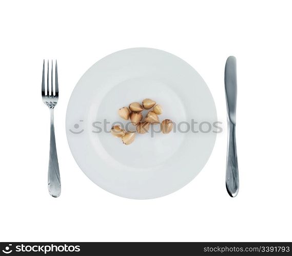 Vegetarian dish - buckwheat. A crude product of the big size on an empty plate