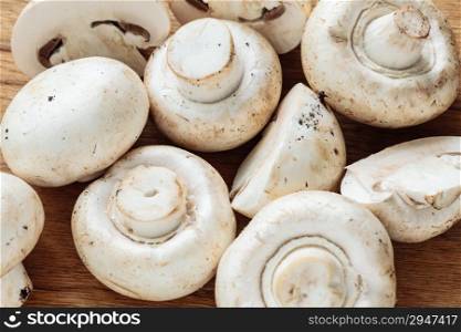 Vegetarian food. Closeup of fresh white mushrooms champigonons as background.