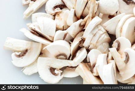 Vegetarian food. Closeup of slices of fresh white mushrooms champigonons.