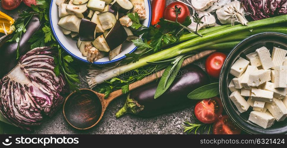 Vegetarian food ingredients with cooking spoon, organic vegetables and feta cheese, top view. Healthy clean eating and diet nutrition concept