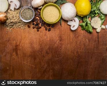 vegetarian food pounded walnuts, lemon, mushrooms, vegetables, raisins on wooden rustic background top view close up border ,place for text