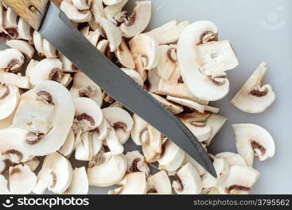 Vegetarian food. Slices of fresh white mushrooms champigonons and kitchen knife.