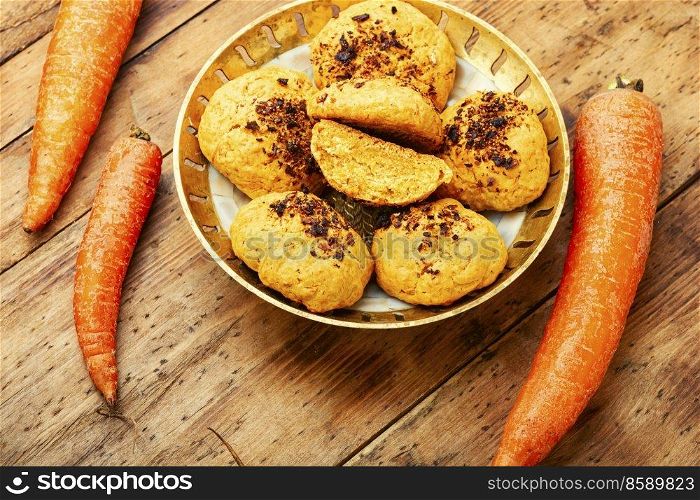 Vegetarian homemade carrot pastry, carrot cookies on wooden surface. Carrot cookies, delicious dessert