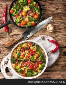 Vegetarian Italian Omelette. Vegetarian Italian omelette with vegetables in frying pan
