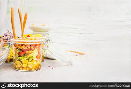 Vegetarian jar salad on light background, side view, place for text. Healthy and clean eating or diet food concept