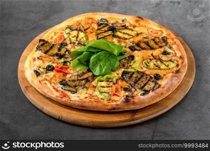 vegetarian pizza with eggplant and zucchini on stone table
