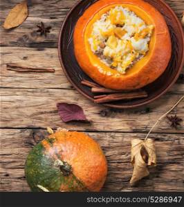 Vegetarian porridge with pumpkin. Pumpkin porridge cooked in a pumpkin on an autumn background