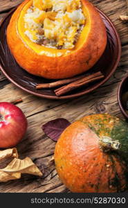 Vegetarian porridge with pumpkin. Pumpkin porridge cooked in a pumpkin on an autumn background