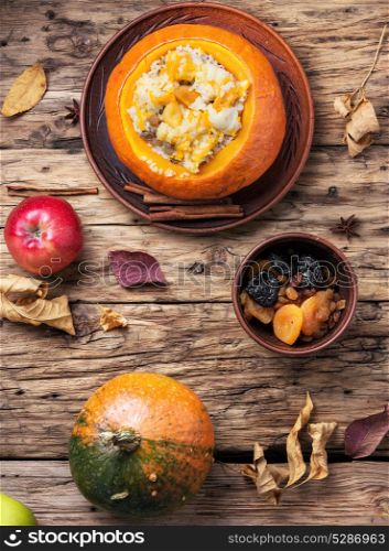 Vegetarian porridge with pumpkin. Pumpkin rice porridge cooked in a pumpkin on an autumn background