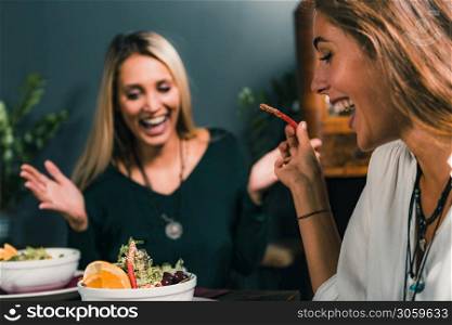 - Vegetarian Restaurant. Blond woman enjoying vegetarian meal in restaurant.