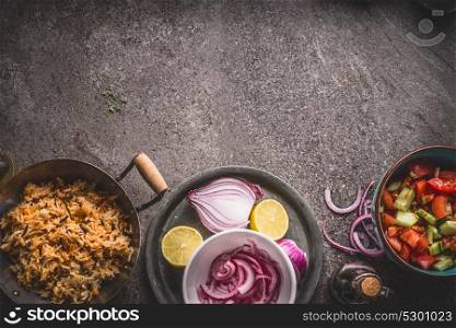 Vegetarian rice in pot with salad on gray stone background, top view. Healthy and clean food and eating concept.