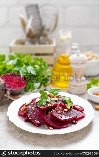 Vegetarian salad with boiled beet, almond nuts and oil. Healthy food