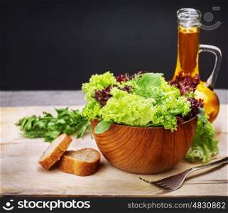 Vegetarian salad with olive oil on the table in kitchen, still life, healthy salad dressing, organic food, tasty nutrition, dieting concept