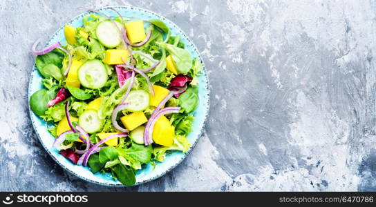 Vegetarian salad with vegetable and mango. Vegan salad of vegetables, herbs and mango.Vegan salad.Diet menu.Lettuce