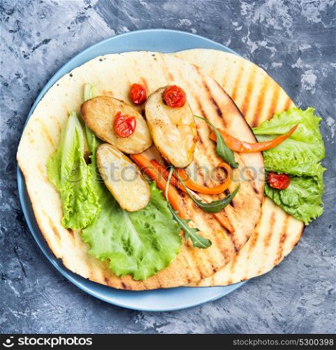 vegetarian tortilla dish. Vegetarian meal.Tuttle dish on a blue stone background