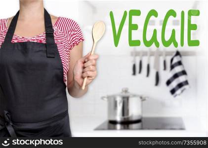 veggie chef holding wooden spoon background.. veggie chef holding wooden spoon background