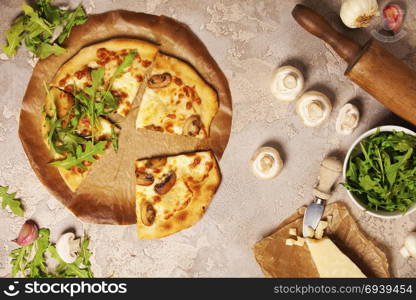 Veggie Pizza with ingredients on old stone background. Pizza with cheese mushrooms and ruccola. Rustic italian pizza