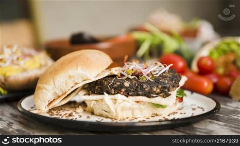veggie quinoa burger with sprouts flax seeds white plate