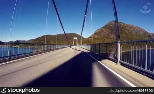 Vehicle point-of-view driving over the bridge.