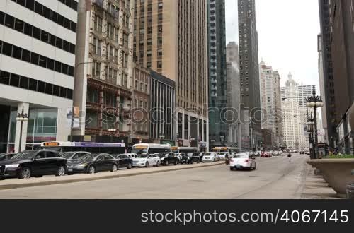 Vehicles in Chicago city center. Loop life in the business financial district on a weekday. Human activity on the streets of Chicago.