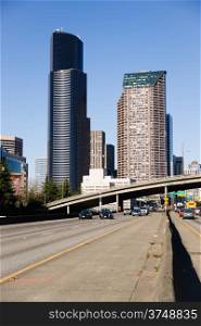 Vehicles travel down Interstate 5 infron of Seattle Downtown