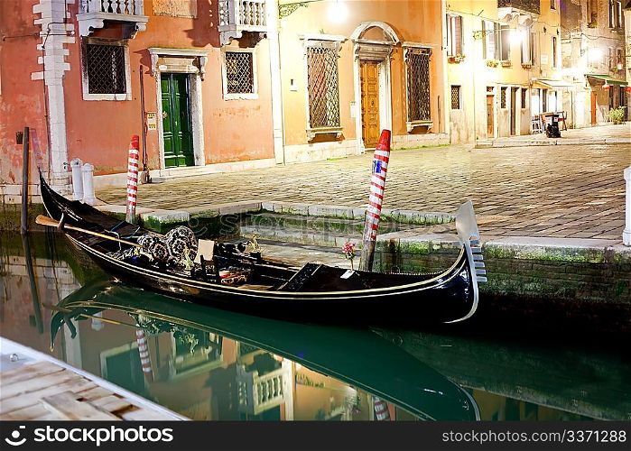 Venetian gondola at night near pier