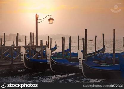 Venetian gondolas at sunrise in venice, Italy&#xA;