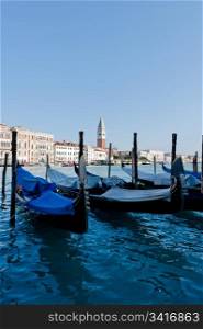 Venetian gondolas. Venetian gondolas, with silhouette reflection in water. San Marco Campanile at background.