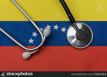 Venezuelan flag and stethoscope. The concept of medicine. Stethoscope on the flag as a background.. Venezuelan flag and stethoscope. The concept of medicine.