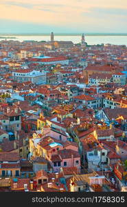 Venice at sunset, Italy. Panoramic view of the old town with tiled roofs from above, cityscape