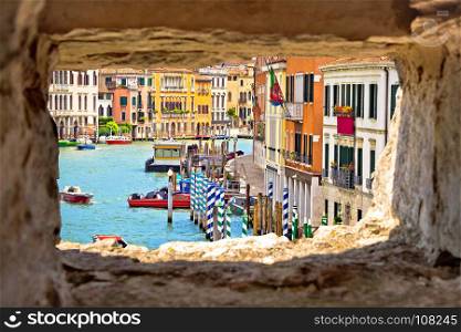 Venice Canal Grande view through stone window, tourist destination in Veneto region of Itally