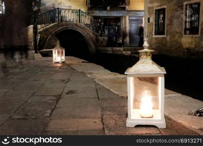 Venice dark old street with bright lantern