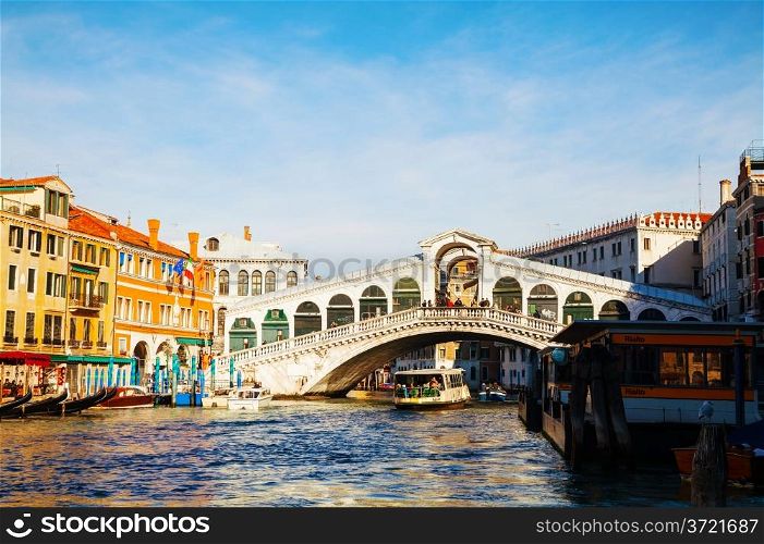 VENICE - DECEMBER 11: Rialto Bridge (Ponte Di Rialto) on a sunny day with tourists on December 11, 2012 in Venice. It&rsquo;s oldest and one of the four bridges spanning the Grand Canal in Venice.