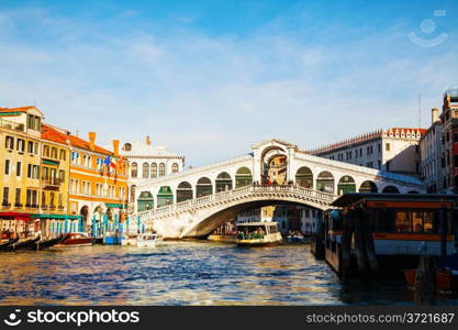 VENICE - DECEMBER 11: Rialto Bridge (Ponte Di Rialto) on a sunny day with tourists on December 11, 2012 in Venice. It&rsquo;s oldest and one of the four bridges spanning the Grand Canal in Venice.