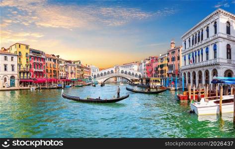 Venice Grand Canal, view of the Rialto Bridge and gondoliers, Italy.. Venice Grand Canal, view of the Rialto Bridge and gondoliers, Italy