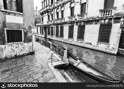 Venice is situated across a group of islands that are separated by canals and linked by bridges. Gondola is a traditional, flat-bottomed Venetian rowing boat. Black and white picture